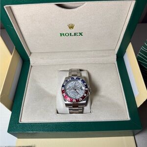 Rolex Silver Watch with Red and Blue Accents